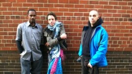 Joseph, Felix and Jeffrey (l to r) have been staying in a temporary shelter since Monday night, when Hurricane Sandy struck. (VOA photo - A. Phillips)