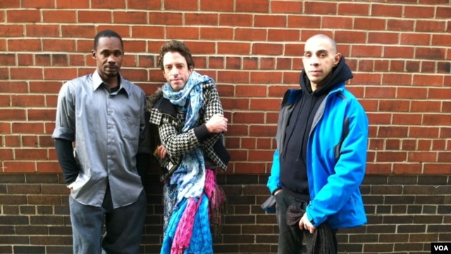 Joseph, Felix and Jeffrey (l to r) have been staying in a temporary shelter since Monday night, when Hurricane Sandy struck. (VOA photo - A. Phillips)