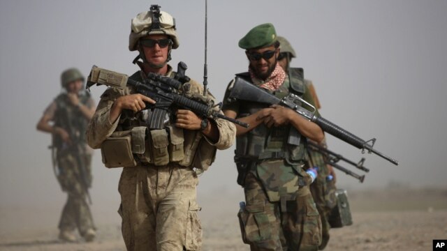 A U.S. Marine and an Afghan soldier are seen on joint patrol in Helmand province, southern Afghanistan (file photo).