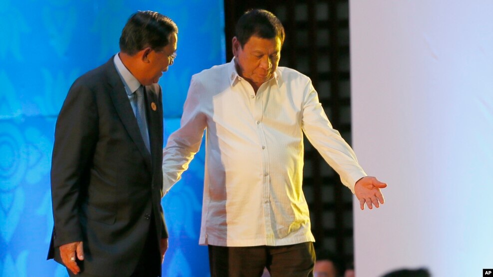 Philippine President Rodrigo Duterte, right, ushers Cambodian Prime Minister Hun Sen following the opening ceremony for the ongoing 28th and 29th ASEAN Summits and other related summits Tuesday, Sept. 6, 2016 in Vientiane, Laos. (AP Photo/Bullit Marquez)