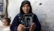 Amal Ibrahim, 57, shows a picture of her son Mohammad in rebel-held Kafrouma village near Idlib, Syria, March 20, 2016. Authorities detained her two sons, and she said she was told one of them, Abdullah, had died from torture. Mohammad's fate wasn't known.