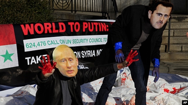 Members of the citizens action and human rights group Avaaz stage a protest with fake blood, body bags and wearing the mask of Syrian leader Bashar al-Assad and Russia's Vladimir Putin outside the United Nations, January 24, 2012.