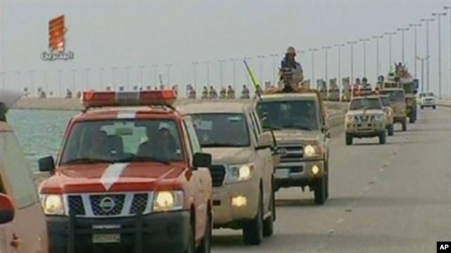 An image grab taken from Bahrain TV shows 'vanguard' of a contingent of Gulf troops arriving in the unrest-wracked Kingdom of Bahrain across a causeway from Saudi Arabia, March 14, 2011