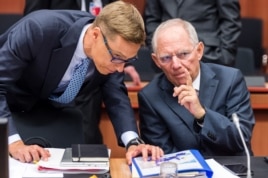 German Finance Minister Wolfgang Schaeuble, right, talks with Finnish Finance Minister Alexander Stubb during a meeting of eurogroup finance ministers at the EU Council building in Brussels, Belgium, July 13, 2015.