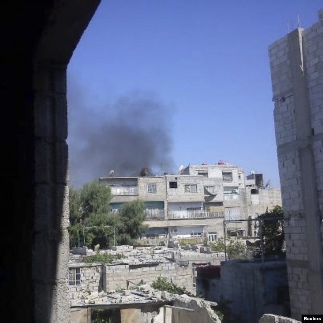 Smoke rises from the suburb of Erbeen in Damascus July 19, 2012.