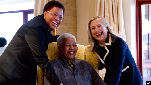 Secretary of State Hillary Rodham Clinton meets with former South Africa President Nelson Mandela and his wife Graca Machel at his home in Qunu, South Africa, Aug. 6, 2012.