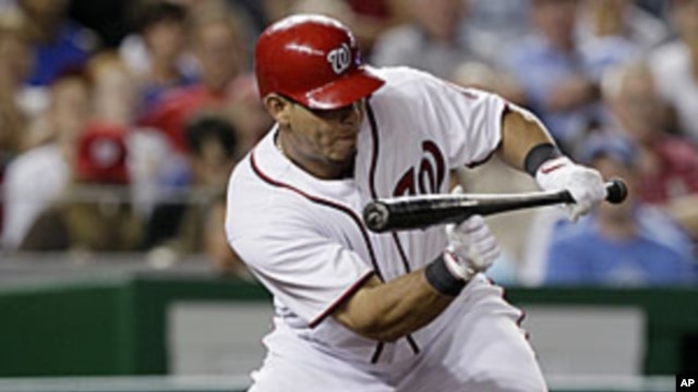 Washington Nationals' Wilson Ramos hitting a sacrifice bunt to drive in teammate Michael Morse for the go-ahead run in the seventh inning against the Chicago Cubs at Nationals Park in Washington, July 6, 2011.