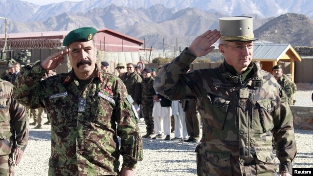 French General Eric Hautecloque Raysz (R) and his Afghan counterpart General Mohammad Zaman Waziri salute during handover ceremony, November 20, 2012.