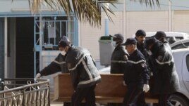 Rescue workers carry the coffin of one of the hostages killed during a hostage crisis in a gas plant at the hospital in In Amenas, January 21, 2013.