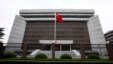 FILE - A Chinese national flag flutters in front of  the Shanghai's No. 1 People's Intermediate Court in Shanghai, China.