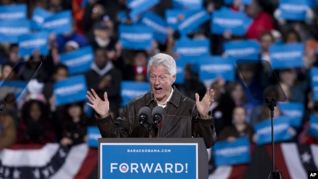 In the final hours of a four-state campaign day, President Barack Obama is introduced by former President Bill Clinton at a rally at Jiffy Lube Live arena, November 3, 2012, in Bristow, Virginia.