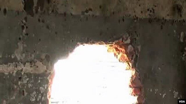 Men's prison in Goma. In the chaos that followed, more than 1,500 men, criminals, escaped from this prison, many of them through this hole in the wall.