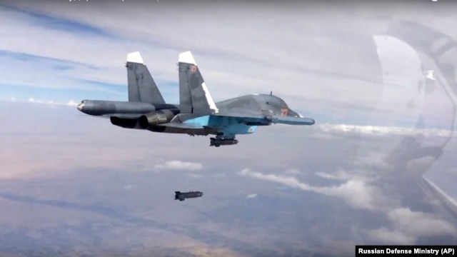 A bomb is released from Russian Su-34 strike fighter in Syria, Oct. 9, 2015.