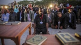 New Somali parliamentarians pray during an inauguration ceremony for members of Somalia's first parliament in 20 years, in Mogadishu, August 20, 2012.