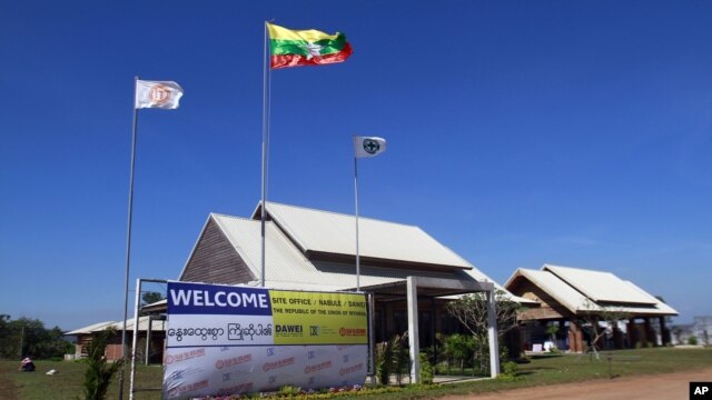 A banner advertising the Dawei Deep Sea Port project is hung on a gate at the site the project, in Nabule township in Dawei, Burma, January 28, 2012.