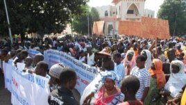 People holding banners take part in a protest called by the Coordination of Patriotic Organizations in Mali (COPAM) against a foreign military intervention in Mali to reclaim the Islamist-controlled north, September 28, 2012.