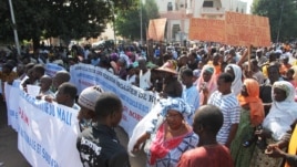 People holding banners take part in a protest called by the Coordination of Patriotic Organizations in Mali (COPAM) against a foreign military intervention in Mali to reclaim the Islamist-controlled north, September 28, 2012.
