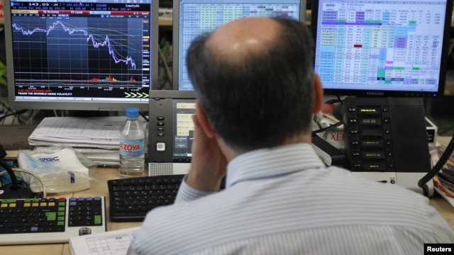 A trader looks at his screens during a bond auction on a trading floor in Madrid, June 7, 2012. 