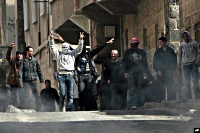 FILE - Anti-Syrian government demonstrators take to the streets in the southern city of Daraa, March 23, 2011.