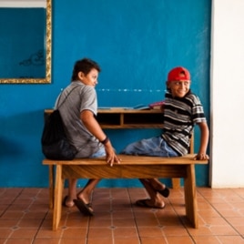 Students in El Cuco, El Salvador, try out a bench and desk made by Surf for Life members Danny Hess and Jay Nelson.