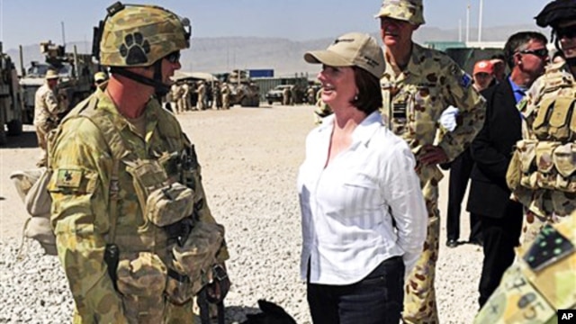 Australian Prime Minister Julia Gillard, center, meets Corporal Craig Turnball and his Explosive Detection Dog during her visit at Multinational Base Tarin Kot in southern Afghanistan, 02 Oct. 2010