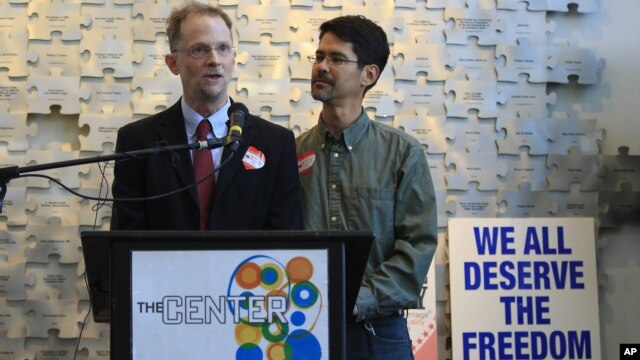 (L-R) Same-sex marriage advocate John Lewis and Stuart Gaffney speak during a celebratory toast to Obama's support of same-sex marriage in San Francisco, California, May 9, 2012.
