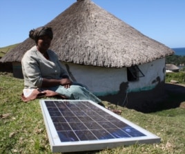 Nozethile Nkwaza powers her shebeen with a solar panel, and declares herself in favor of the radical anti-alcohol law (D. Taylor/VOA)