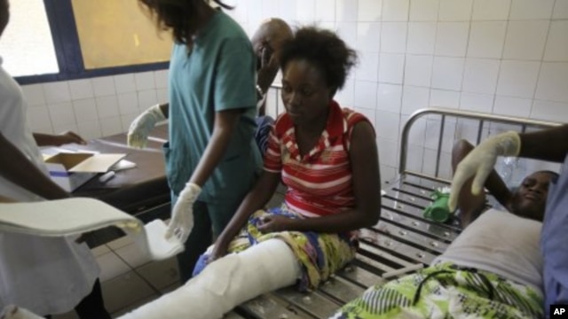 A woman is treated at the central hospital after a series of explosions destroyed homes and buildings in the Mpila neighborhood of Congo Republic's capital Brazzaville, March 5, 2012. 