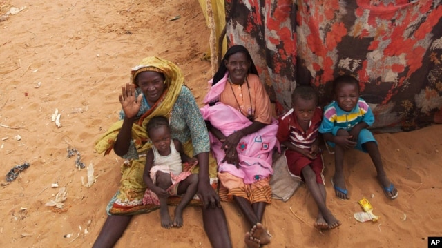 Photo released by the United Nations African Union Mission in Darfur (UNAMID) shows women and their children outside their tents at the Zam Zam refugee camp for internally displaced people (IDP) in North Darfur, Sudan, June 11, 2014.