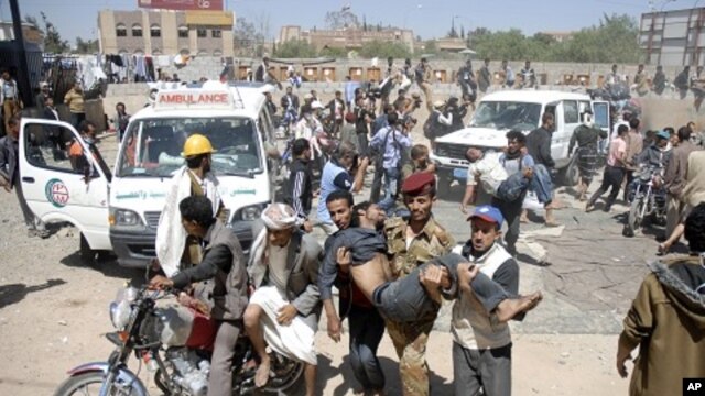 Anti-government protesters carry fellow protesters at a makeshift clinic after they were injured in a demonstration demanding the ouster of Yemen's President Ali Abdullah Saleh in Sanaa October 25, 2011.