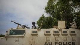 Ugandan police officer serving with the African Union Mission in Somalia's first Formed Police Unit stands at the top of an armored personnel carrier at a police station in the capital Mogadishu, August 7, 2012.