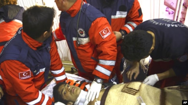 Turkish rescuers tend Ferhat Tokay, 13, after he was pulled from the rubble of a collapsed building in Ercis, Van, Turkey, October 28, 2011.