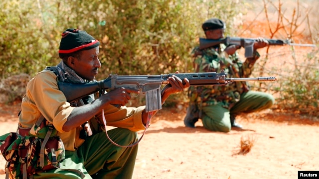 FILE - Kenyan policemen hold their position while patrolling the Kenya-Somalia border near the town of Mandera. A string of attacks earlier this month have raised safety concerns about in the Mandera region.