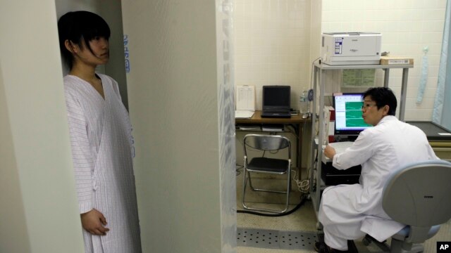 Satomi Kuroki, a 13-year-old junior high school student, receives a whole-body counter radiation check at Minimisoma City General Hospital just outside the 20-kilometer Fukushima Prefecture, Japan, March 7, 2012.  