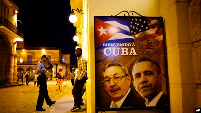 A poster features portraits of Cuba's President Raul Castro, left, and U.S. President Barack Obama and reads in Spanish "Welcome to Cuba" outside a restaurant in Havana, Cuba, March 17, 2016. Obama is scheduled to travel to the island on March 20, the first U.S. presidential trip to Havana in nearly 90 years. 