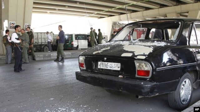 View of broken glass from a damaged police car at the site of a bomb blast in central Damascus April 27, 2012. 