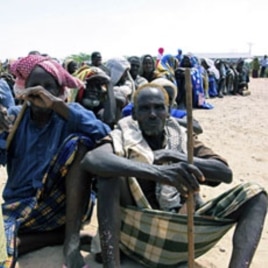 Somali's wait for food aid to be handed out from the UNHCR in Mogadishu , Wednesday. Aug. 31.2011