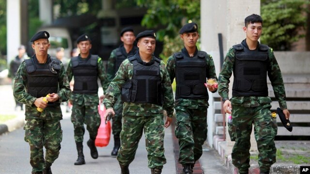 FILE - Thai soldiers walk after being deployed to guard at Bangkok's Victory Monument, Thailand, June 8, 2014.