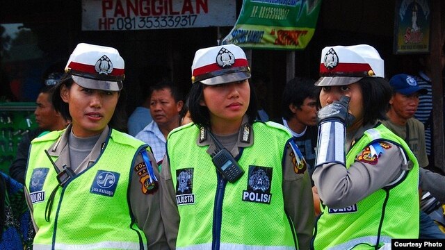 Polisi wanita berjaga-jaga dalam parade seni di Denpasar, Bali. 