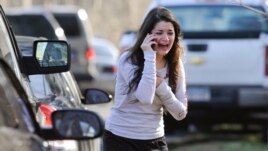 A woman waits to hear about her sister, a teacher, following a shooting at the Sandy Hook Elementary School in Newtown, Connecticut.