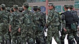 Armed police officers patrol an ethnic Uighur area in Kashgar, in Xinjiang province Aug. 4, 2011.