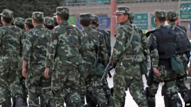 Armed police officers patrol an ethnic Uighur area in Kashgar, in Xinjiang province Aug. 4, 2011.