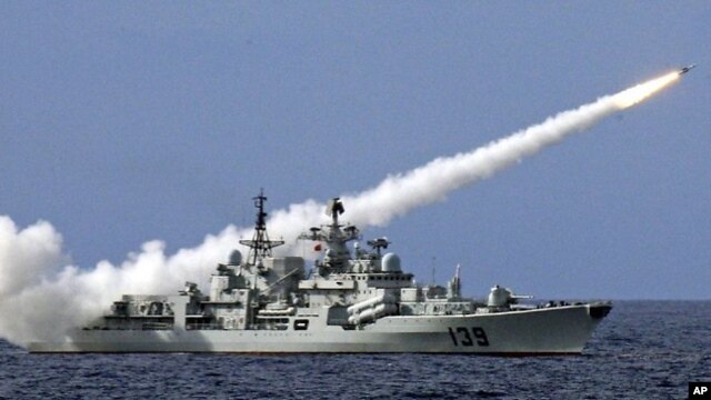 FILE - A Chinese warship launches a missile during a live-ammunition military drill in the South China Sea.