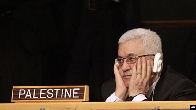 Palestinian President Mahmoud Abbas listens to US President Barack Obama's remarks during the 66th session of the General Assembly at United Nations headquarters, New York, September 21, 2011.