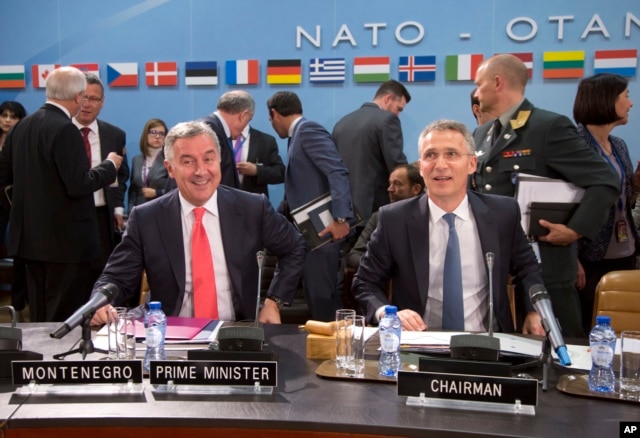 FILE - NATO Secretary-General Jens Stoltenberg, right, and Montenegro's Prime Minister Milo Dukanovic, left, take their seats during a meeting of the North Atlantic Council and Montenegro at NATO headquarters in Brussels, May 19, 2016.