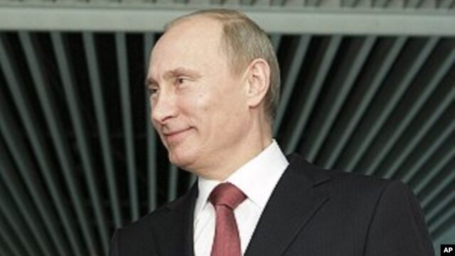 Russian Prime Minister Vladimir Putin gestures while speaking to journalists in Moscow, April 13, 2011