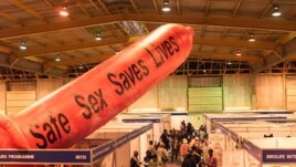 A giant condom inflates over the exhibition stands at Nasrec Exhibition Center, Johannesburg, South Africa, August 2002. (AP Photo/Obed Zilwa)