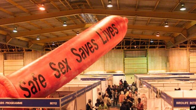A giant condom inflates over the exhibition stands at Nasrec Exhibition Center, Johannesburg, South Africa, August 2002. (AP Photo/Obed Zilwa)
