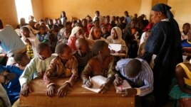 Children listen to a school teacher after the reopening of Mahamane Fondogoumo elementary school in the town center of Timbuktu, Mali, February 1, 2013.