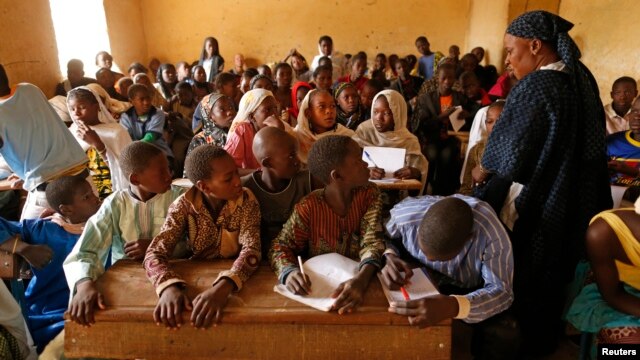 Children listen to a school teacher after the reopening of Mahamane Fondogoumo elementary school in the town center of Timbuktu, Mali, February 1, 2013.